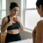 why do boobs sag after weight loss — woman examining breast changes in mirror